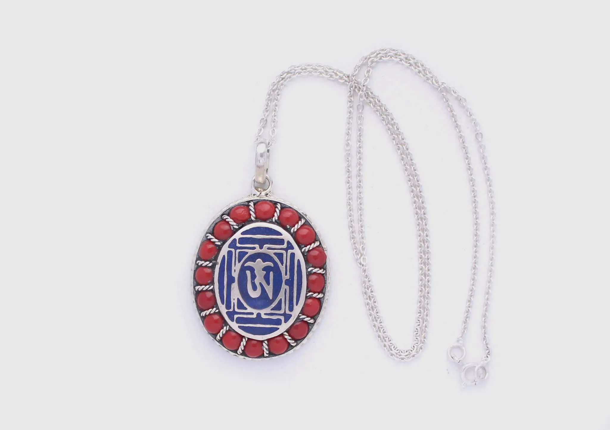 Coral Inlaid Buddha Eyes and Tibetan Om Painted White Metal Pendant