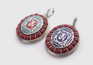 Coral Inlaid Buddha Eyes and Tibetan Om Painted White Metal Pendant